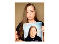 An image of Sarah Turney holding a picture of her half-sister Alissa Turney (Image via Sarah Turney)